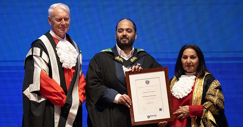 Mr Anant Ambani in black University gown is presented certificate by Professor Chris Day in red Vice-Chancellor's gown and by Imtiaz Dharker in red Chancellor's gown.